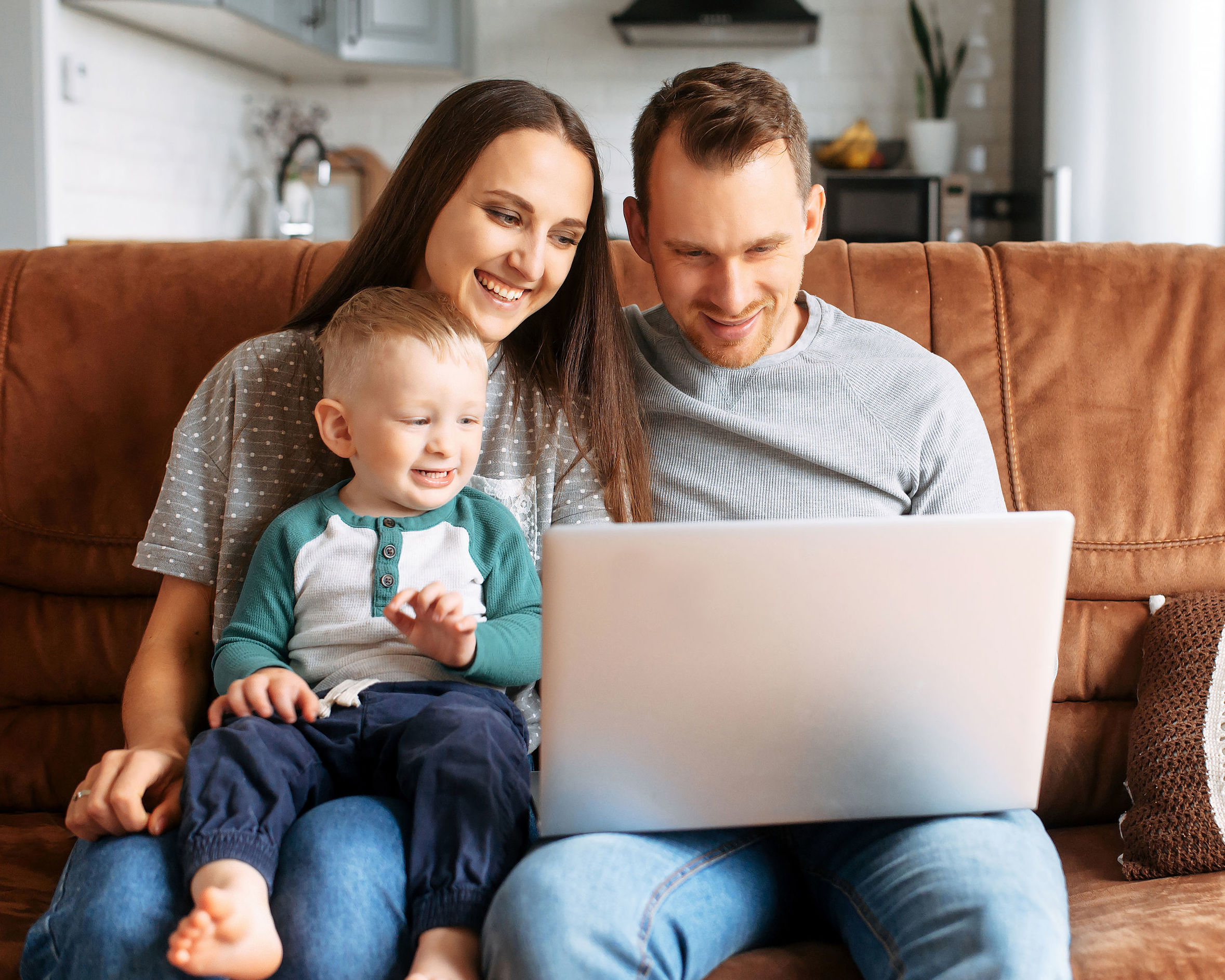 A young family communicating via video with family